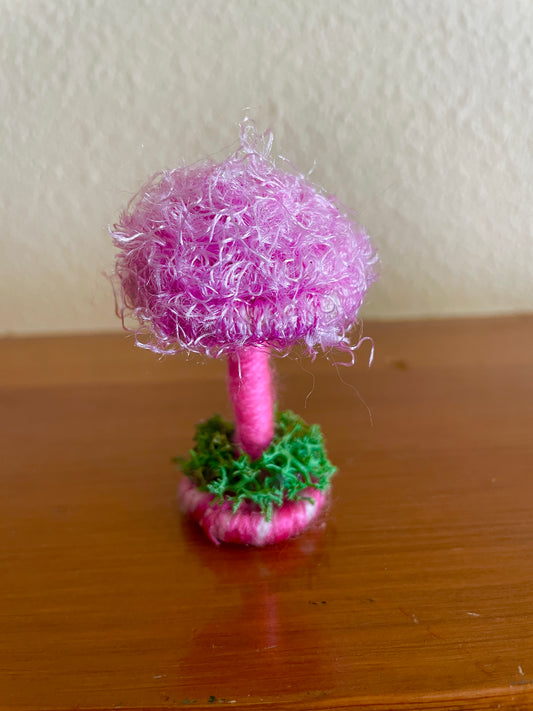 Fuzzy pink Mushroom collectible Made with fuzzy pink yarn wrapped around rope and shaped into a mushroom with small flat platform adorned with moss for standing, perfect for mushroom lovers and or collectors, can also be used as an ornament (hook is included in order)  Materials: acrylic yarn, rope, hot glue  Dimensions: