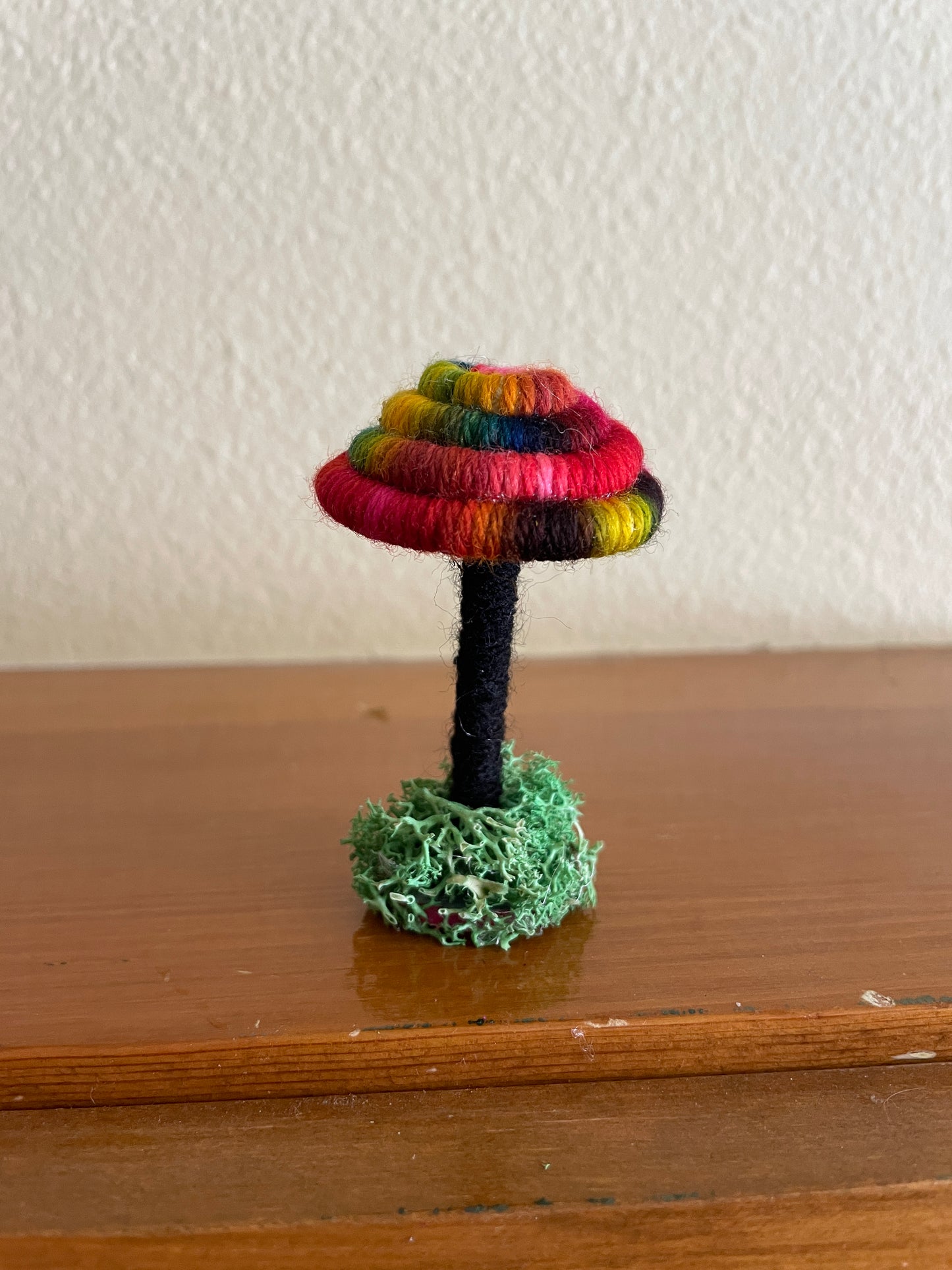 tie dye mirror Made with bright multicolored yarn wrapped around rope and shaped into a mushroom with small flat platform for standing, perfect for mushroom lovers and or collectors, can also be used as an ornament (hook is included in order)  Materials: acrylic yarn, rope, hot glue  Dimensions: