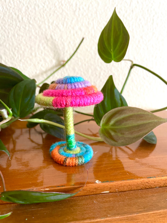 psychedelic mushroom collectible Made with bright multicolored yarn wrapped around rope and shaped into a mushroom with small flat platform for standing, perfect for mushroom lovers and or collectors, can also be used as an ornament (hook is included in order)  Materials: acrylic yarn, rope, hot glue