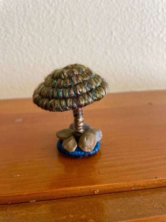 Dark green Mushroom, Made with dark green yarn wrapped around rope and shaped into a mushroom with small flat platform adorned with rocks for standing, perfect for mushroom lovers and or collectors, can also be used as an ornament (hook is included in order)  Materials: acrylic yarn, rope, hot glue