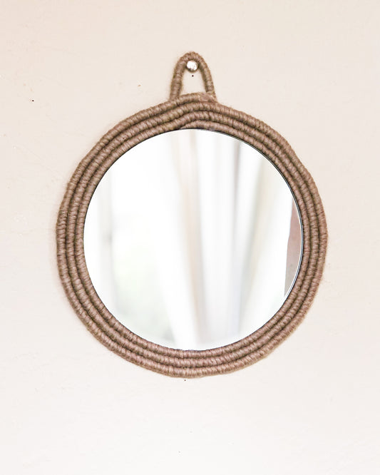 taupe mirror This mirror is framed with Taupe yarn wrapped around rope.  Perfect for the neutral tone lovers out there, could be hung up in your foyer to check on your face before leaving the house.  Dimensions: Mirror is 8 inches in diameter, with frame its 10 inches total in diameter  Materials: yarn, rope, mirror, hot glue